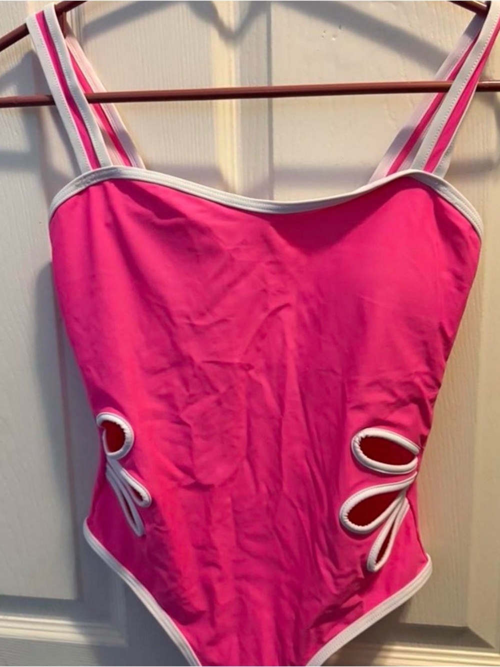 New. Pink one piece swimsuit with white trim and bow details. Size: 14